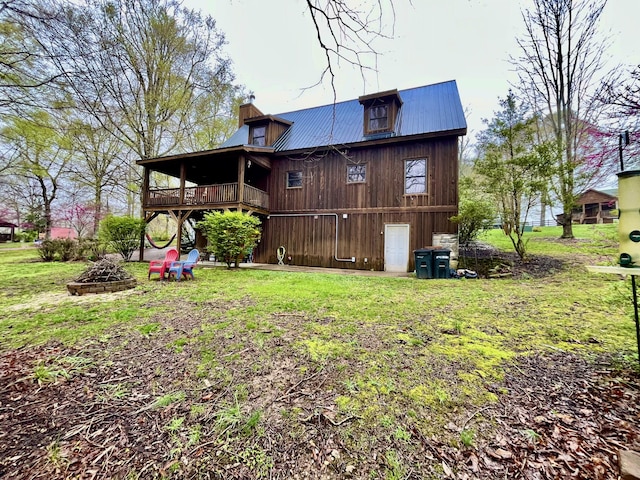 130 The Village Dr, Nancy, KY 42544 - rear view of property with a wooden deck, a yard, an outdoor fire pit, metal roof, and a chimney