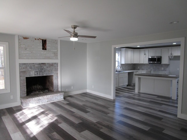 596 Overlook Dr, Lancaster, KY 40444 - unfurnished living room featuring a sink, ceiling fan, dark wood finished floors, and baseboards