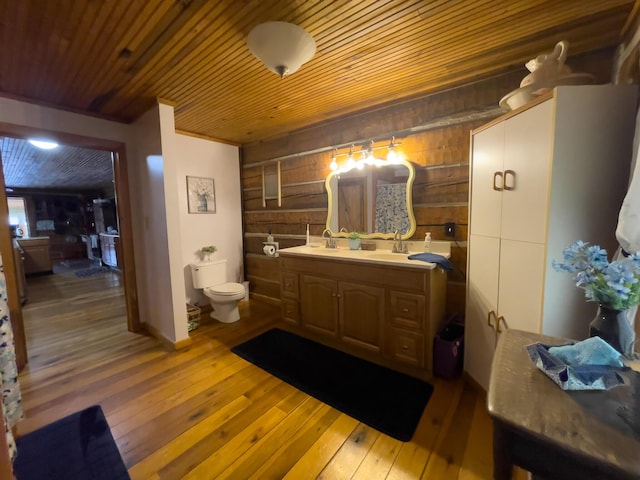 350 Wilderness Ln, Morehead, KY 40351 - bathroom featuring toilet, wood-type flooring, wooden walls, and a sink