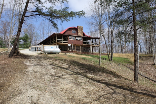 350 Wilderness Ln, Morehead, KY 40351 - back of house featuring a gambrel roof, an exterior structure, dirt driveway, an outdoor structure, and a chimney