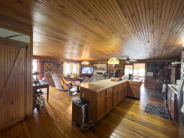 350 Wilderness Ln, Morehead, KY 40351 - kitchen with open floor plan, pendant lighting, wood-type flooring, and a stone fireplace