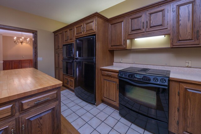 400 Redding Rd Unit 15, Lexington, KY 40517 - kitchen featuring a chandelier, butcher block countertops, black appliances, and light tile patterned flooring
