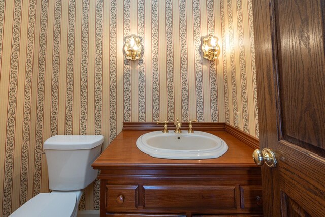 400 Redding Rd Unit 15, Lexington, KY 40517 - half bathroom with vanity, wallpapered walls, and toilet