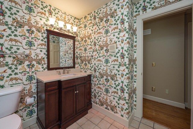 400 Redding Rd Unit 15, Lexington, KY 40517 - bathroom featuring vanity, toilet, tile patterned floors, wallpapered walls, and baseboards