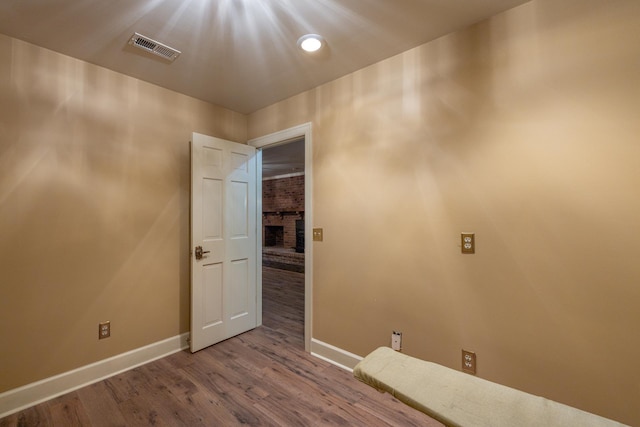 unfurnished room featuring visible vents, baseboards, and wood finished floors