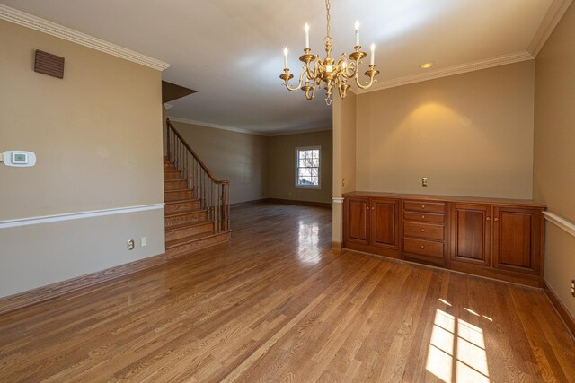 400 Redding Rd Unit 15, Lexington, KY 40517 - unfurnished room with light wood-style floors, ornamental molding, stairs, a notable chandelier, and baseboards