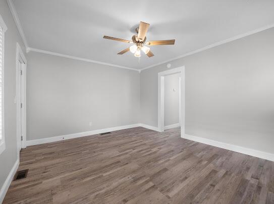 513 Washington Ave, Paintsville, KY 41240 - spare room with baseboards, crown molding, a ceiling fan, and wood finished floors