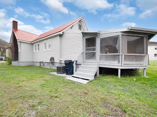 513 Washington Ave, Paintsville, KY 41240 - rear view of property with a sunroom, a yard, metal roof, and a chimney
