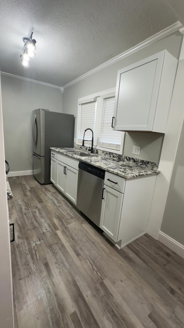 513 Washington Ave, Paintsville, KY 41240 - kitchen featuring a sink, ornamental molding, appliances with stainless steel finishes, dark wood-style floors, and light stone counters