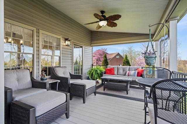 deck with an outdoor living space and ceiling fan