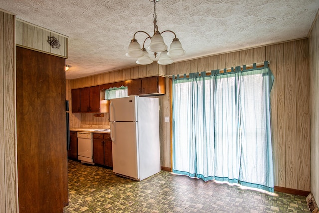 176 Marsee Trl, Corbin, KY 40701 - kitchen with white appliances, a chandelier, a textured ceiling, wooden walls, and dark floors