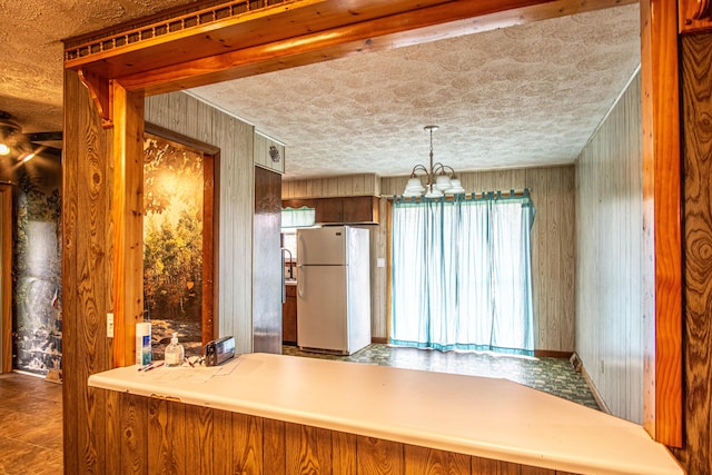 176 Marsee Trl, Corbin, KY 40701 - kitchen featuring wood walls, freestanding refrigerator, and a chandelier