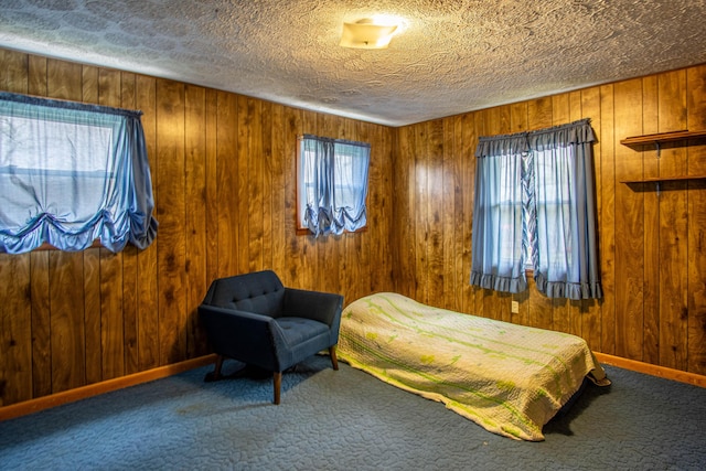 176 Marsee Trl, Corbin, KY 40701 - carpeted bedroom featuring wooden walls, baseboards, and a textured ceiling