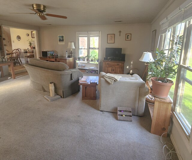 living area featuring a ceiling fan and light colored carpet