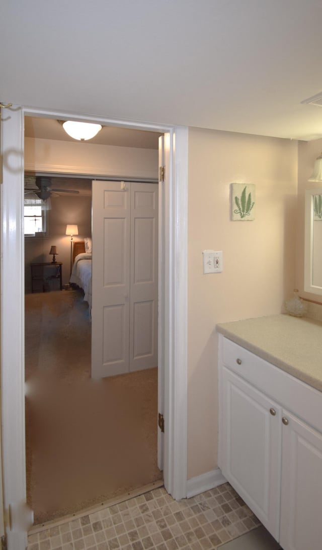 bedroom with ceiling fan, a closet, light colored carpet, and multiple windows