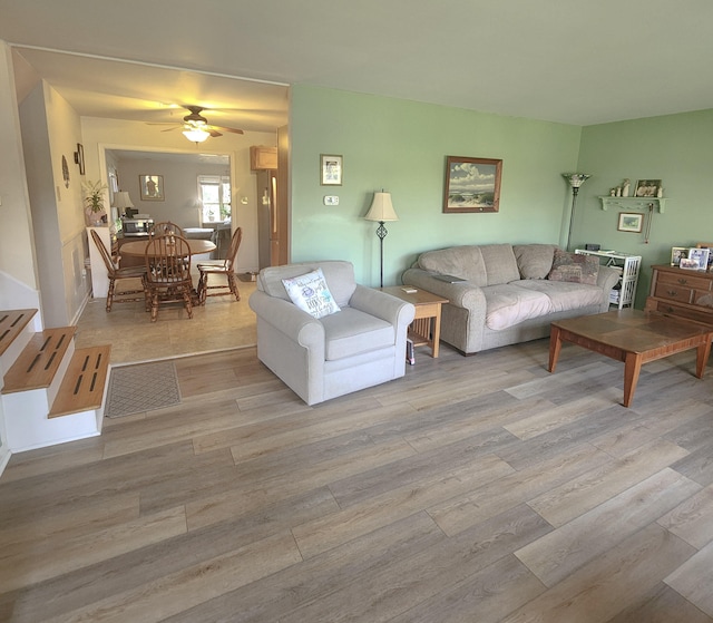 living room featuring wood finished floors and a ceiling fan