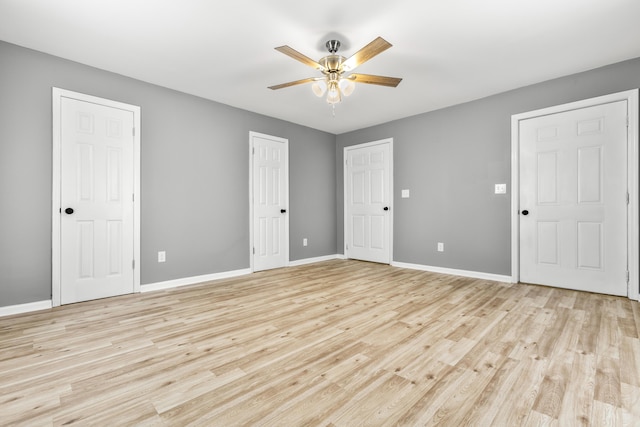 280 Main St, Salt Lick, KY 40371 - unfurnished bedroom featuring light wood-style flooring, baseboards, a ceiling fan, and multiple closets