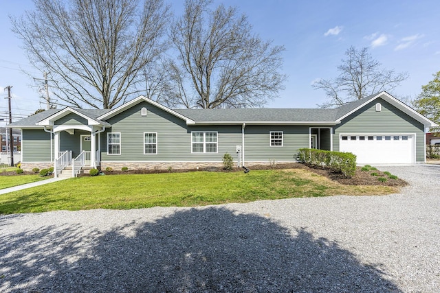 ranch-style house featuring a garage, gravel driveway, and a front yard