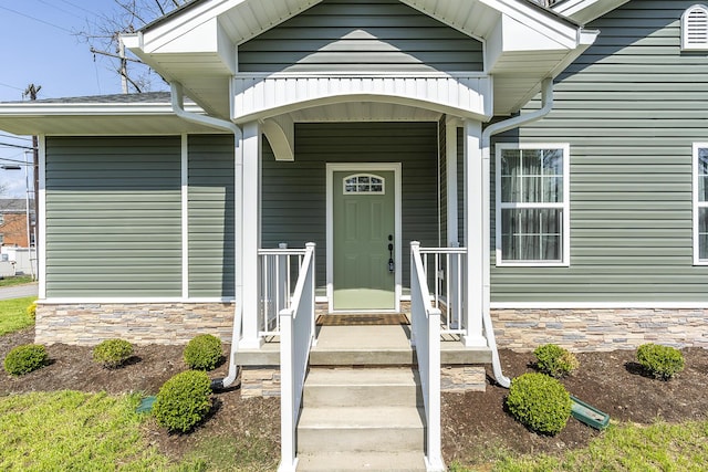 doorway to property with stone siding