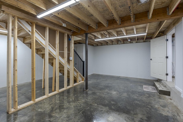 unfinished below grade area featuring stairway