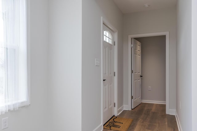 hall with baseboards and dark wood-style flooring