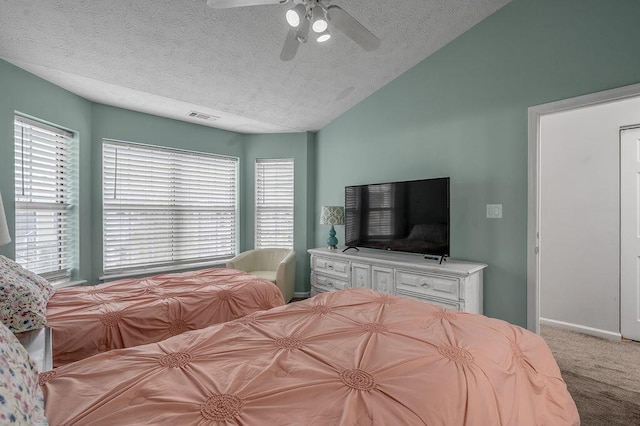 carpeted bedroom featuring a textured ceiling, ceiling fan, lofted ceiling, and visible vents