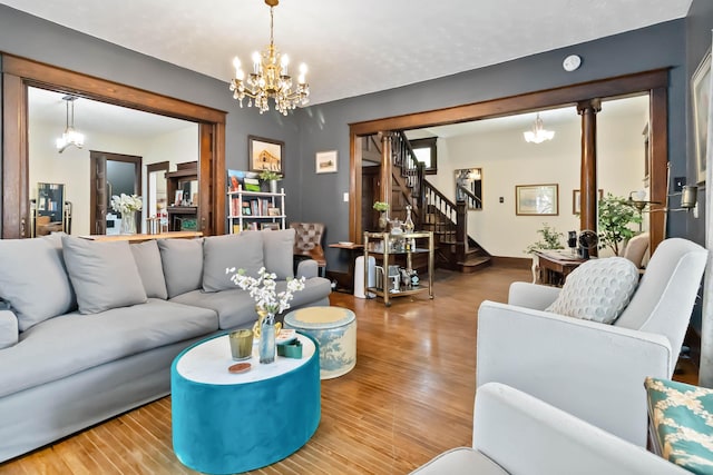 309 W Columbia St, Somerset, KY 42501 - living room with stairway, an inviting chandelier, and wood finished floors