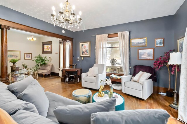 309 W Columbia St, Somerset, KY 42501 - living area with wood finished floors, decorative columns, a notable chandelier, and baseboards