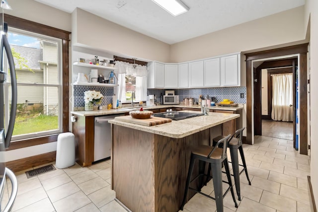 309 W Columbia St, Somerset, KY 42501 - kitchen with white cabinetry, visible vents, a center island, appliances with stainless steel finishes, and decorative backsplash
