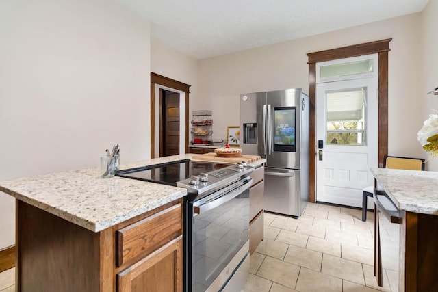 309 W Columbia St, Somerset, KY 42501 - kitchen with brown cabinets, light tile patterned floors, light stone countertops, and stainless steel appliances