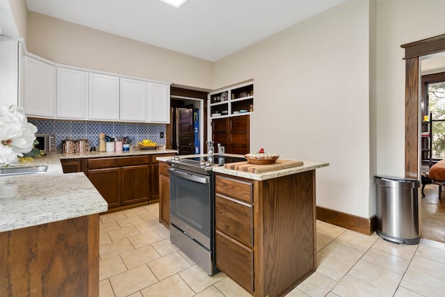 309 W Columbia St, Somerset, KY 42501 - kitchen with tasteful backsplash, light tile patterned floors, stainless steel range with electric stovetop, an island with sink, and white cabinetry