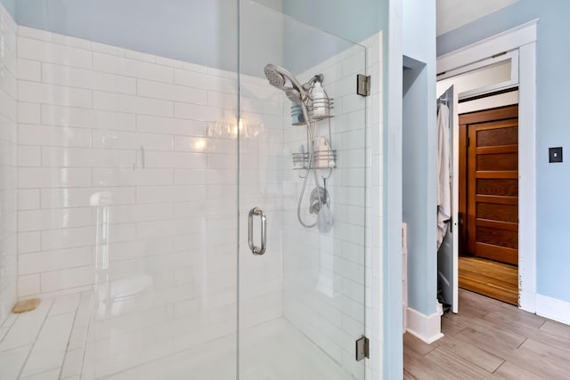 309 W Columbia St, Somerset, KY 42501 - bathroom with baseboards, a stall shower, and wood finished floors