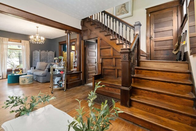 309 W Columbia St, Somerset, KY 42501 - stairway with a chandelier and wood finished floors