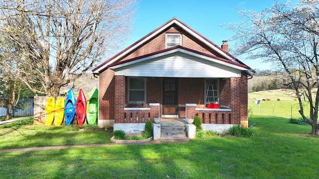 3473 Grundy Rd, Somerset, KY 42501 - bungalow-style house featuring brick siding, a chimney, a front lawn, and covered porch