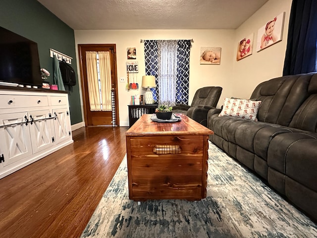 3473 Grundy Rd, Somerset, KY 42501 - living area with dark wood-type flooring, baseboards, and a textured ceiling