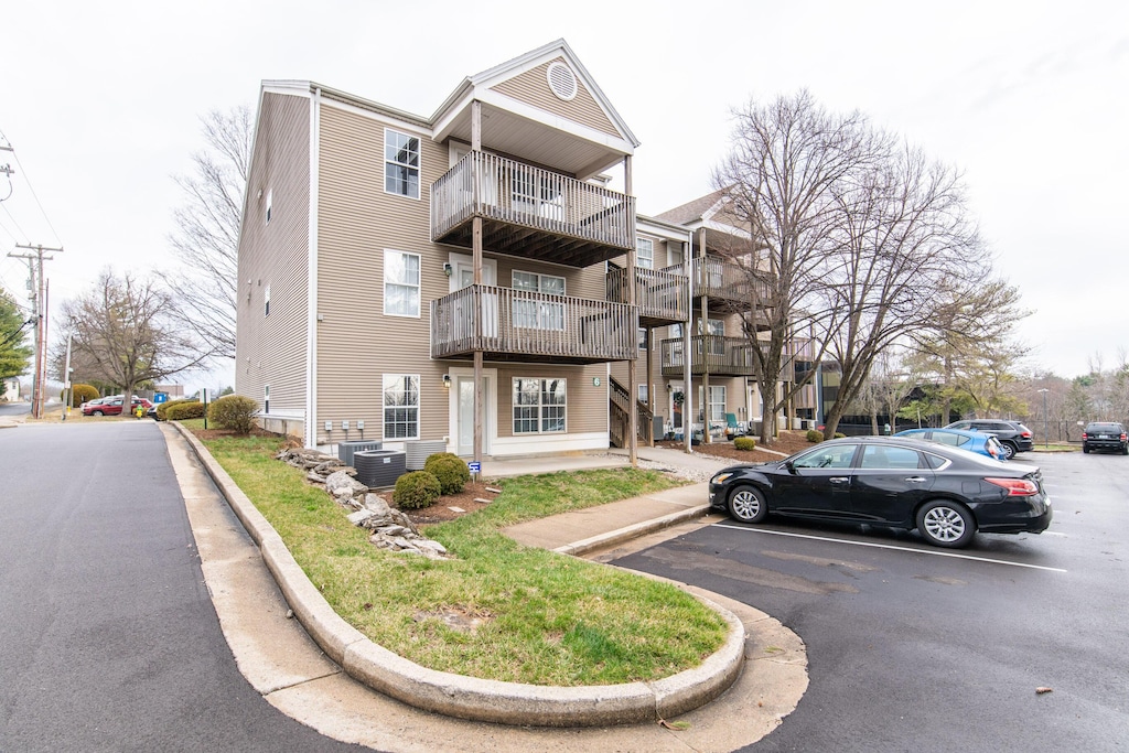858 Malabu Dr Unit 5000, Lexington, KY 40502 - view of property featuring central air condition unit and uncovered parking