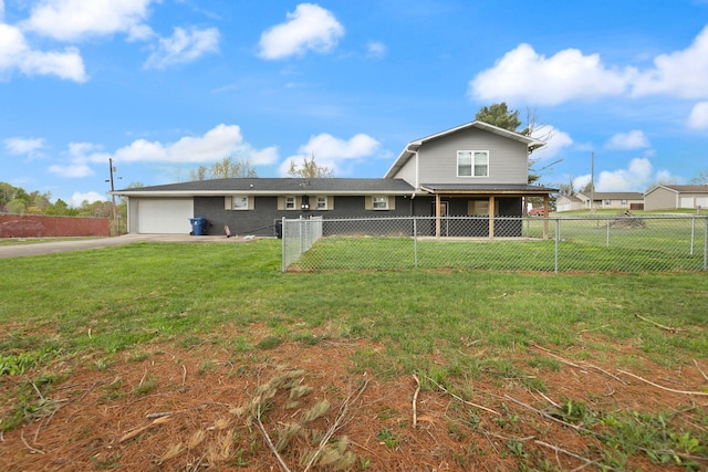 view of front of house with concrete driveway, a front yard, and an attached garage