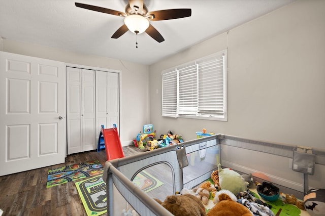bedroom with wood finished floors, a closet, a ceiling fan, and baseboards