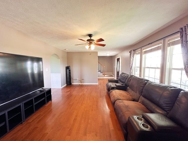 305 Saddle Wood Ct, Berea, KY 40403 - living room featuring stairway, light wood-style floors, arched walkways, a wealth of natural light, and a ceiling fan