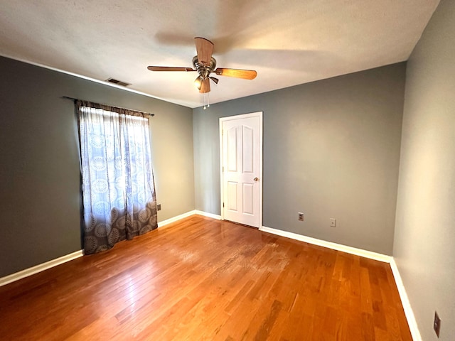 305 Saddle Wood Ct, Berea, KY 40403 - spare room featuring wood finished floors, a ceiling fan, visible vents, and baseboards