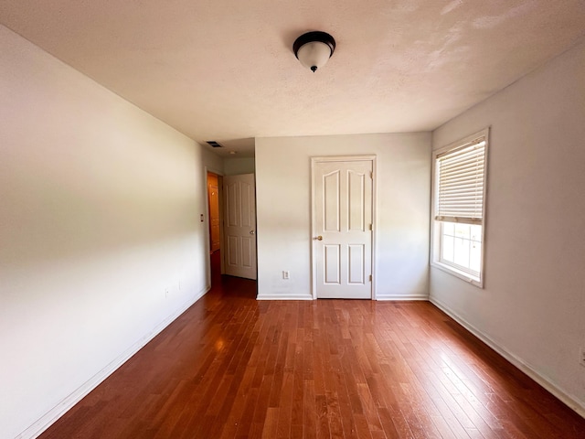 305 Saddle Wood Ct, Berea, KY 40403 - unfurnished bedroom featuring baseboards, visible vents, and dark wood-type flooring