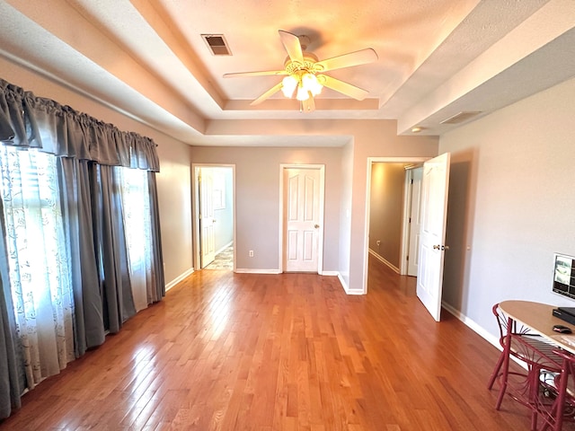 305 Saddle Wood Ct, Berea, KY 40403 - unfurnished bedroom featuring a raised ceiling, baseboards, visible vents, and light wood-style floors