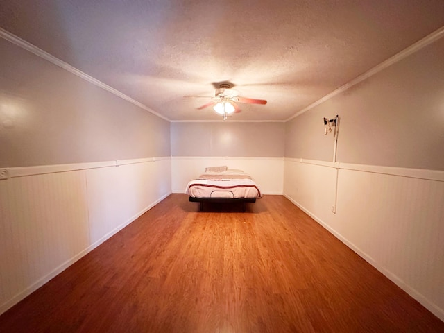 305 Saddle Wood Ct, Berea, KY 40403 - bedroom with a textured ceiling, wood finished floors, ceiling fan, and a wainscoted wall