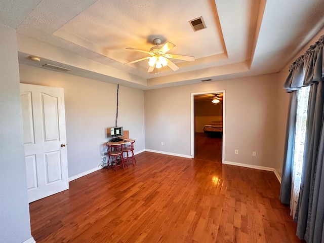 305 Saddle Wood Ct, Berea, KY 40403 - unfurnished room featuring visible vents, a raised ceiling, a ceiling fan, and wood finished floors