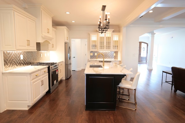 2524 Pascoli Pl, Lexington, KY 40509 - kitchen featuring stainless steel appliances, decorative columns, arched walkways, a sink, and ornamental molding