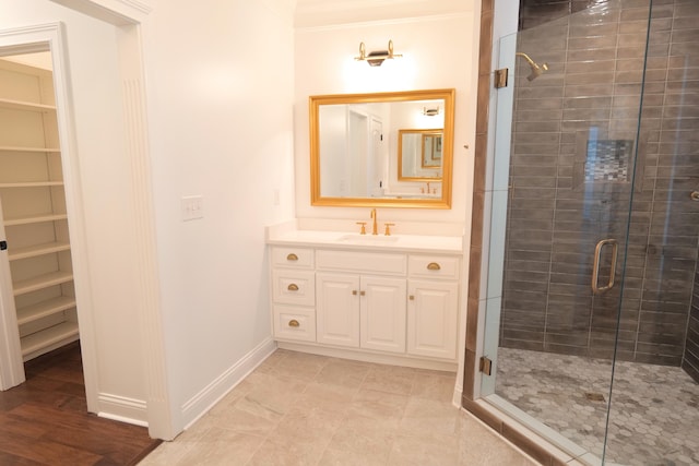 2524 Pascoli Pl, Lexington, KY 40509 - bathroom featuring a shower stall, vanity, crown molding, baseboards, and a walk in closet