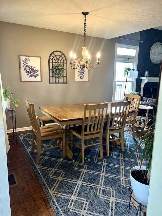 111 Keystone Dr, Richmond, KY 40475 - dining space with an inviting chandelier, a textured ceiling, lofted ceiling, baseboards, and dark wood-style floors