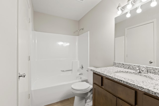 bathroom featuring toilet, wood finished floors, vanity, and  shower combination