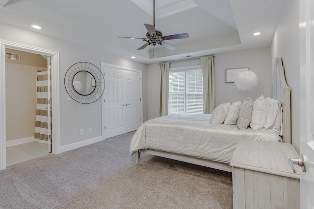 bedroom with a tray ceiling, visible vents, recessed lighting, carpet floors, and baseboards