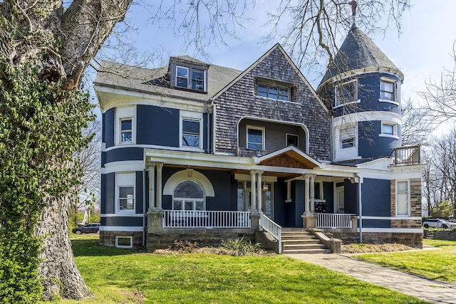 victorian home with a porch and a front yard